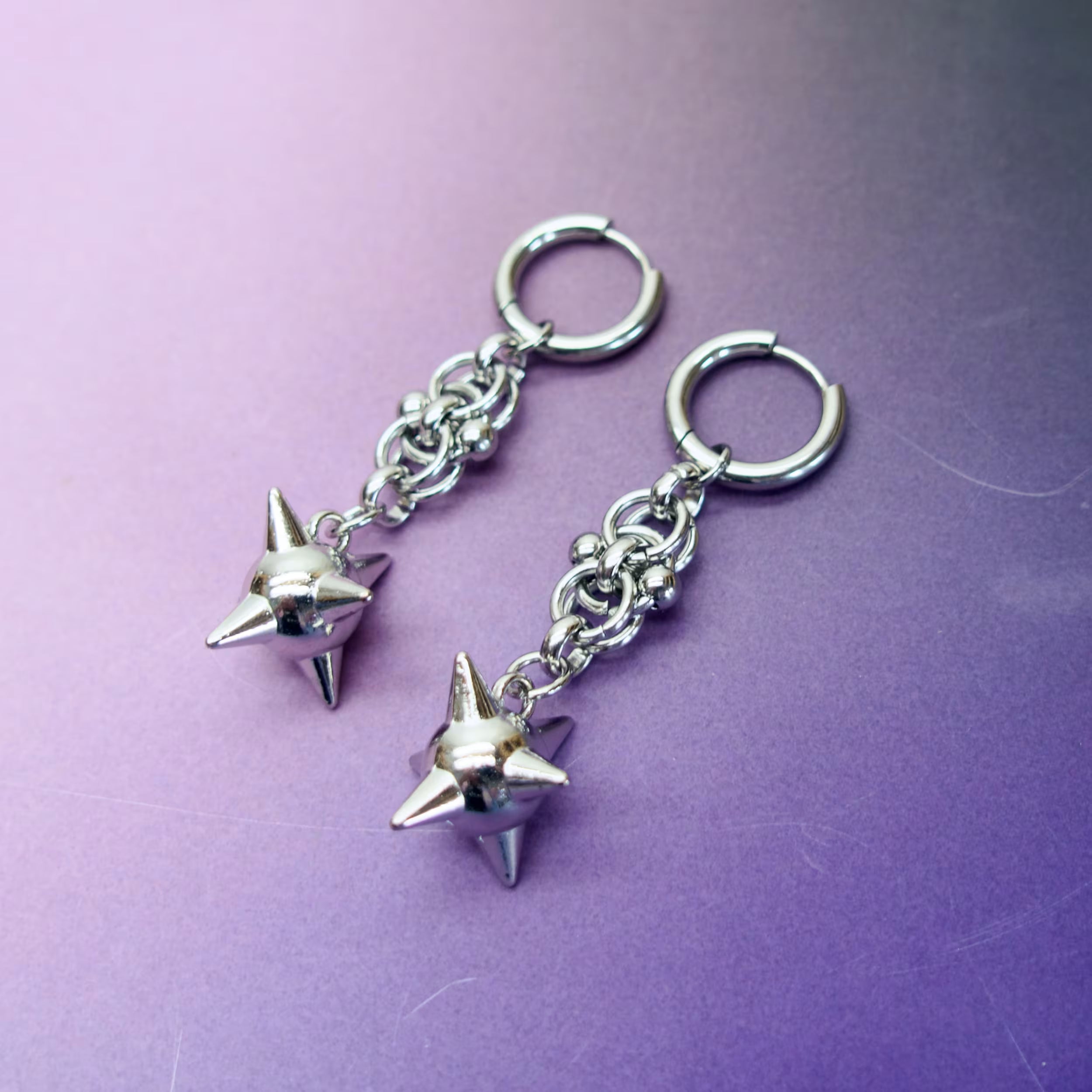 Punk chain earrings with silver spikes — stainless steel hoops and gothic alternative jewellery design.