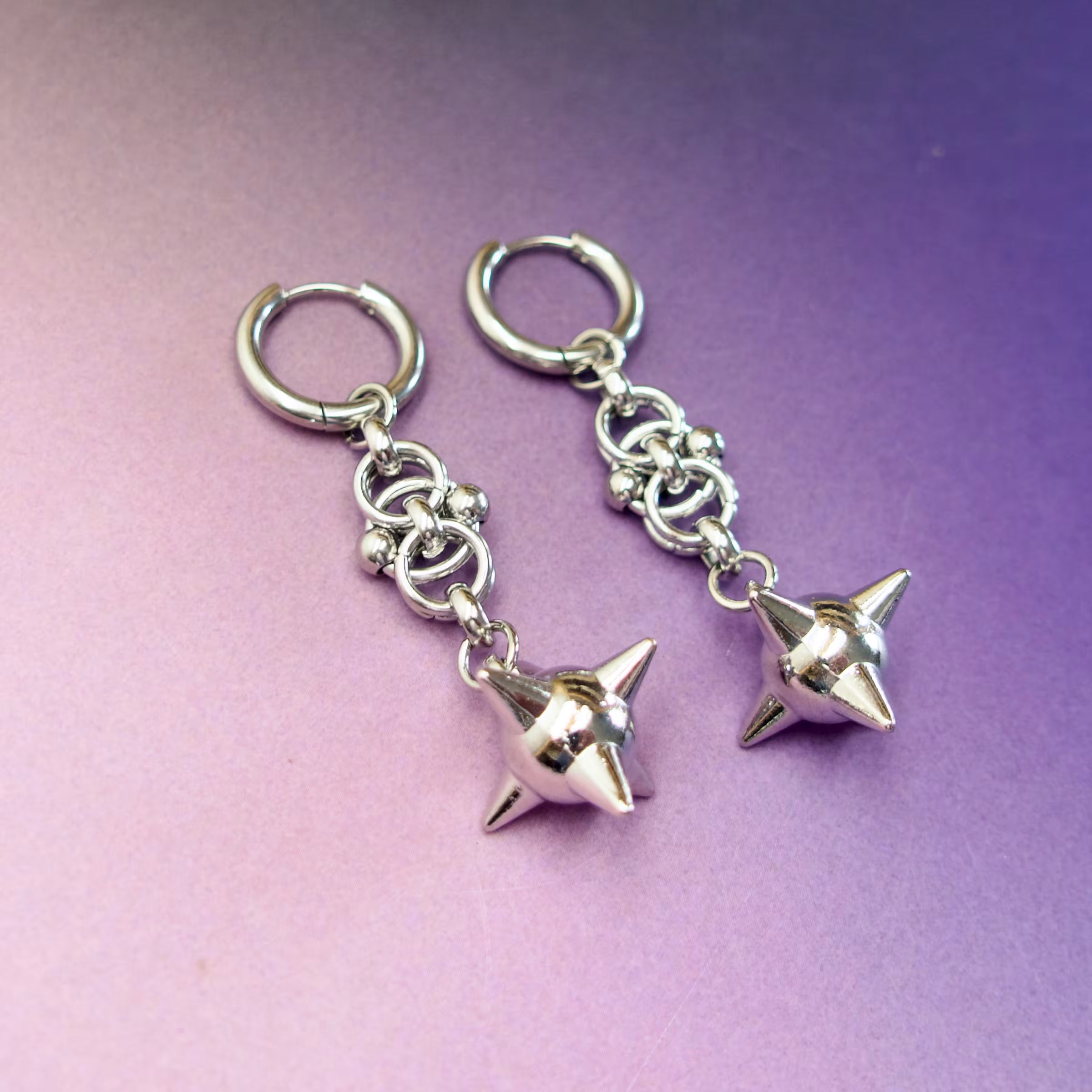 Stainless steel hoop earrings with spiked ball charms — edgy punk gothic statement jewellery.