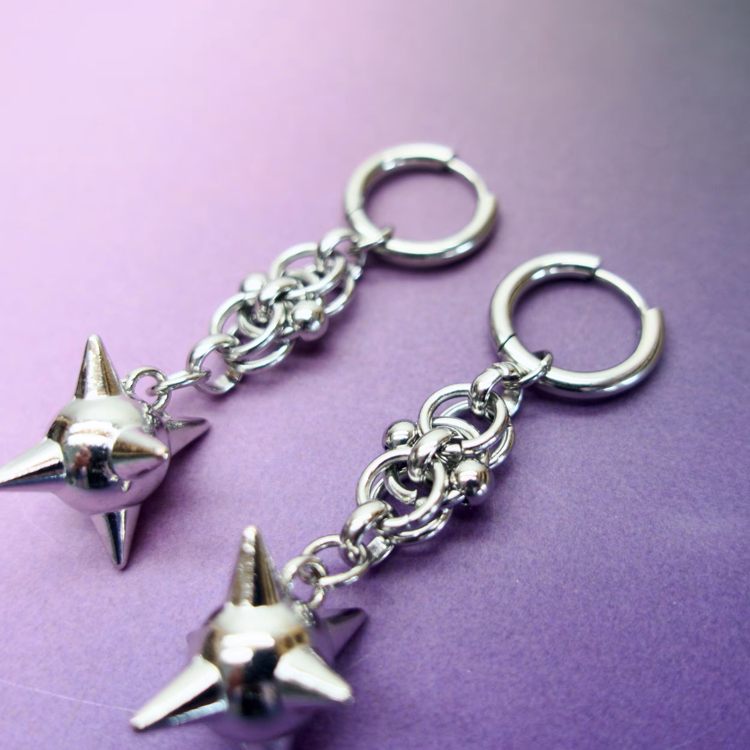Alternative fashion earrings featuring metal spike charms — bold gothic punk aesthetic.