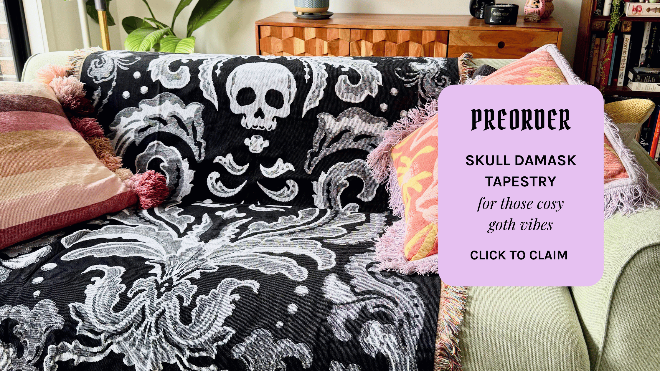 Skull damask tapestry on a couch with promotional text overlay